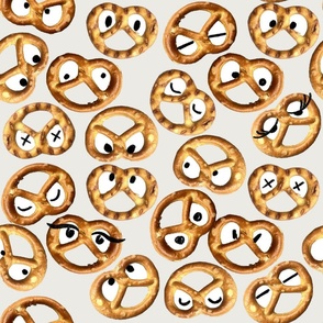 Funny pretzels smiling faces on white. Salty snacks.