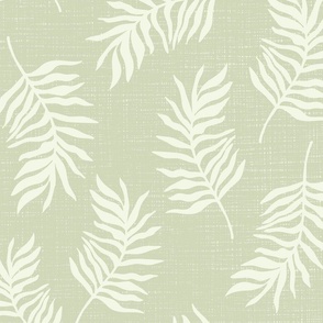 Light green tropical leaves on textured green background