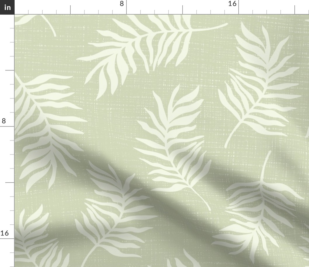 Light green tropical leaves on textured green background