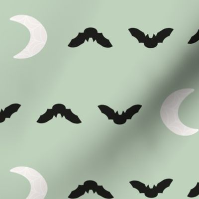 cute pastel halloween bats and spiderweb moons in black and off white on light mint sage green