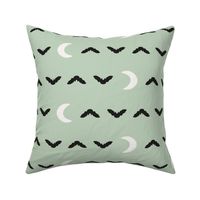 cute pastel halloween bats and spiderweb moons in black and off white on light mint sage green