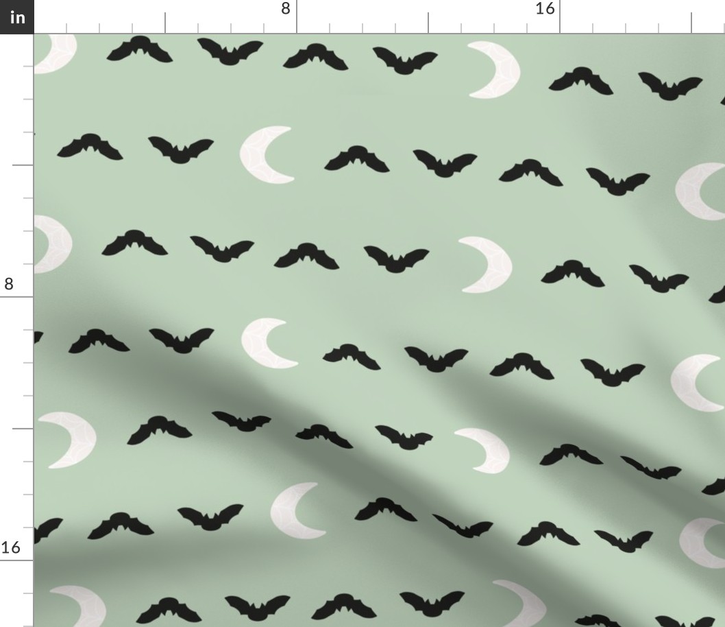 cute pastel halloween bats and spiderweb moons in black and off white on light mint sage green