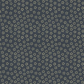 Small sparkly gold stars on woven dark blue background