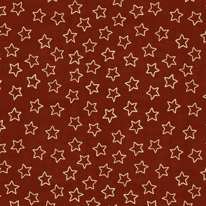 Sparkly gold stars on woven dark red background