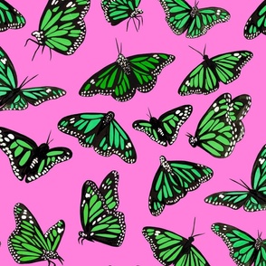 hand painted monarch butterflies in green on a pink background 
