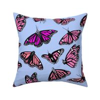 hand painted monarch butterflies in pink on a blue background 
