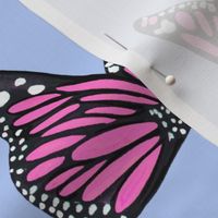 hand painted monarch butterflies in pink on a blue background 