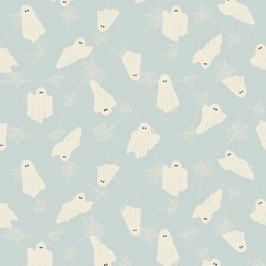 cute ghosts and webs on light blue