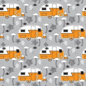 small halloween trailers and flamingos on grey