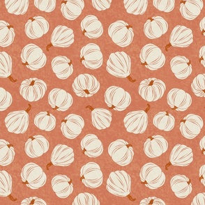 Tossed pumpkins on a caramel background - fall collection 