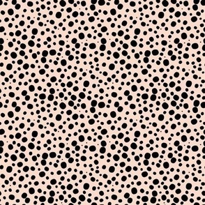 Black dots spots on baby pink  