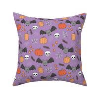 Sweet boho style halloween bats pumpkins and leaves halloween candy garden orange coral lilac on purple violet