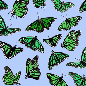 hand painted monarch butterflies in green on a blue background 