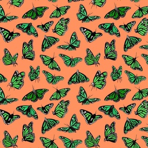 hand painted monarch butterflies in green on a orange background - smaller scale
