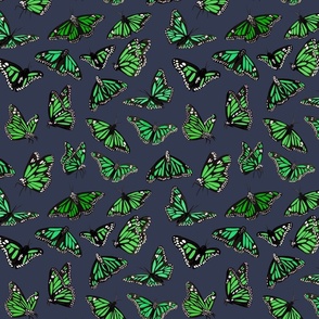 hand painted monarch butterflies in green on a grey background - smaller scale