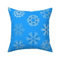 Calligraphic Christmas snowflakes on ice blue