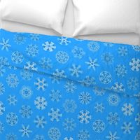 Calligraphic Christmas snowflakes on ice blue