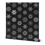 Calligraphic Christmas snowflakes on black