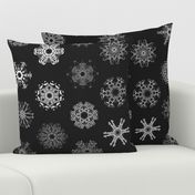 Calligraphic Christmas snowflakes on black