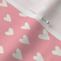 cream hearts on a dusty rose background