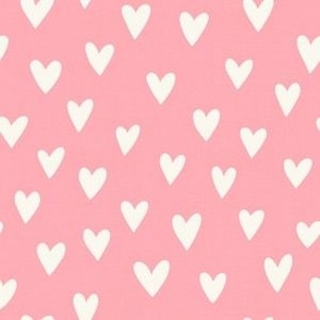 cream hearts on a dusty rose background