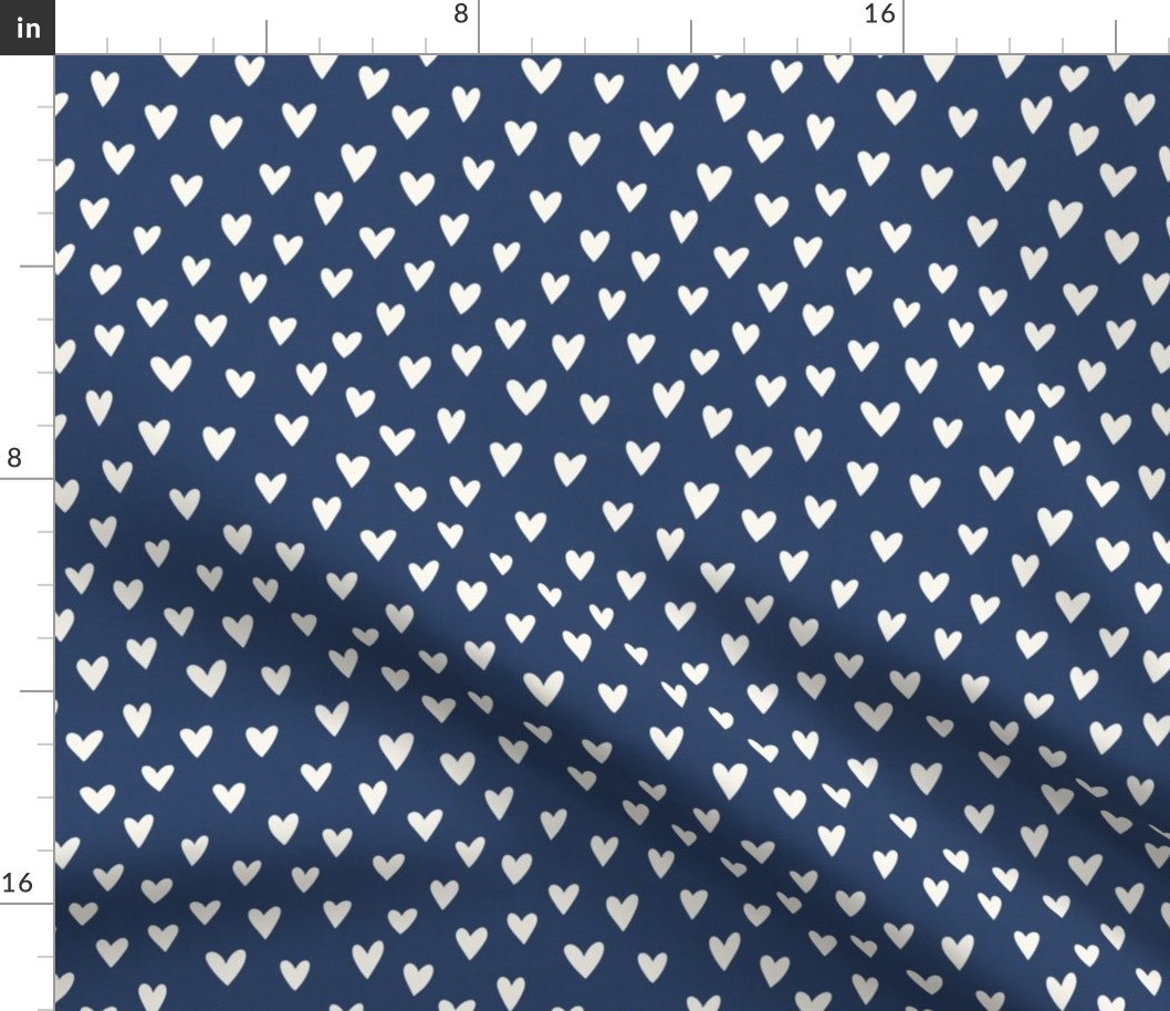 cream hearts on a navy blue background