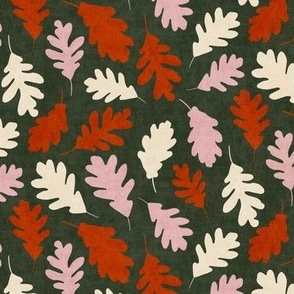 Cream, red orange, pink oak leaves on green background - large scale