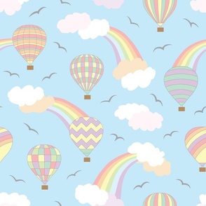 Whimsical pastel hot air balloons, clouds, rainbows and birds design on a pale blue background