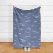 Chambray Cotton Clouds in Stonewash Blue (xl scale) | Hand drawn, summer clouds on natural cotton, chambray pattern, warp and weft weave pattern, sky with clouds on stonewash denim blue.