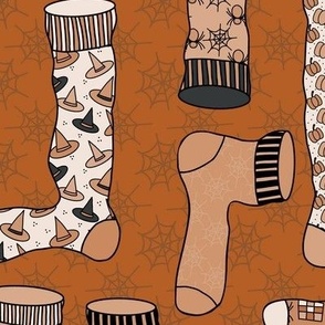 457 - Large scale monochromatic caramel spice and black witch socks, booties and stockings with spiders, hats, spiderwebs,  stripes, zigzags and pumpkins, for Halloween  apparel, costumes and  party table linens.