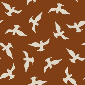 (M) beige birds flying in the mahogany sky