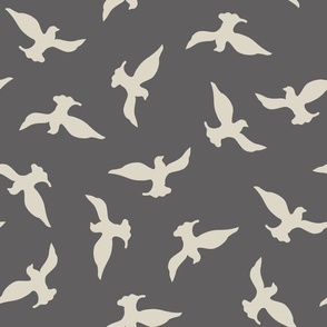 (M) beige birds flying in the dark grey sky