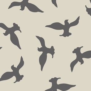 (M) grey birds flying in the beige sky