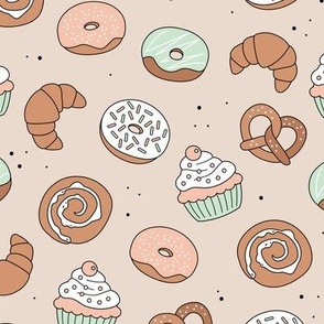 The german bakery - pretzels croissants donuts cupcakes and cinnamon buns sugary snacks for breakfast blush mint on sand soft pastel neutral palette