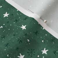 Stars and snow on a green background