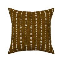 rustic mud cloth on rusty yellow linen texture