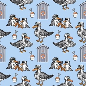 Seagull, beach hut, bucket & spade seaside pattern on sea blue.