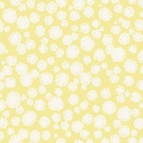pompom cream on pastel yellow
