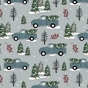 Driving home for Christmas - Winter wonderland christmas pine trees and pick up cars driving in the forest moody blue on cool gray