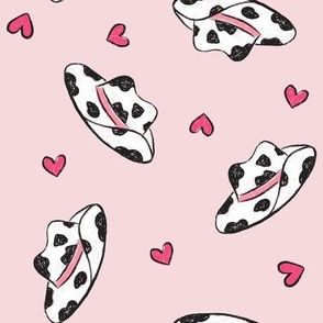 Cowhide Cowgirl Hats and Hearts on Pink Background