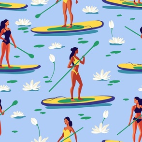 Woman in a swimsuit on a SUP board on the lake