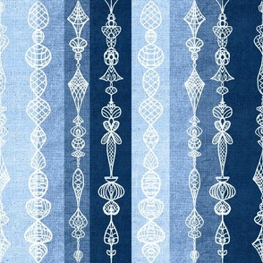 Vertical burlap textured stripes with white handdrawn lace effect overlay small 12” repeat monochrome blues. Light blue, denim blue, indigo blue 