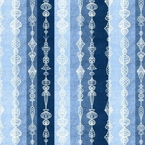 Vertical burlap textured stripes with white handdrawn lace effect overlay small 6” repeat monochrome blues. Light blue, denim blue, indigo blue 