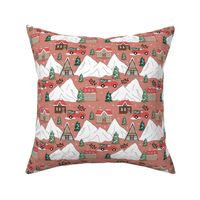 Vintage Christmas- Mountain cabins and christmas trees driving home for Christmas seasonal winter wonderland and snowy mountain peaks red green on vintage brick