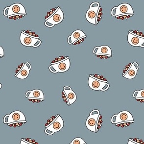 Cutesy Christmas hot chocolate and coffee cups and smileys with little marshmallows candy retro kids design on moody blue