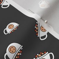 Cutesy Christmas hot chocolate and coffee cups and smileys with little marshmallows candy retro kids design on charcoal gray