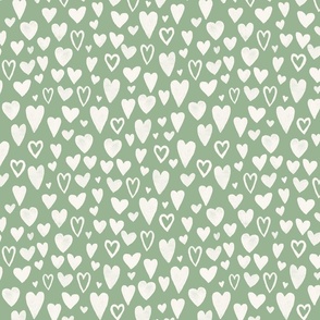 hand drawn chalk hearts on solid green