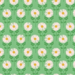 Small-scale sweet daisy print in colors of golden yellow, orange, pink, and green. 

