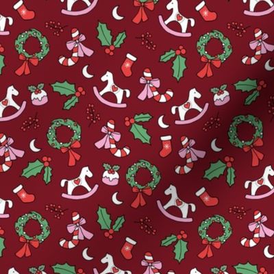 Cutesy Christmas retro wreath mistletoe candy cane pudding moon rocking horse and stockings seasonal ornaments and icons pink red green on burgundy