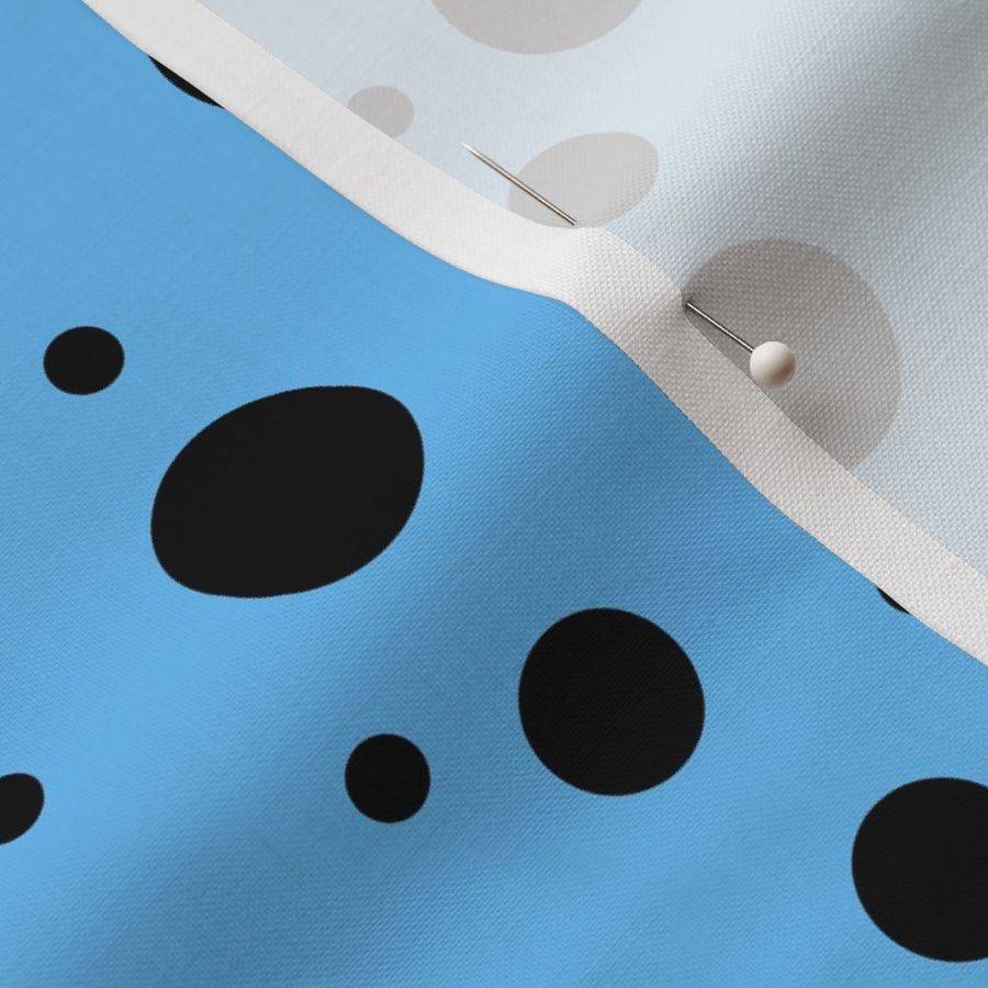 varying polkadots black on light blue